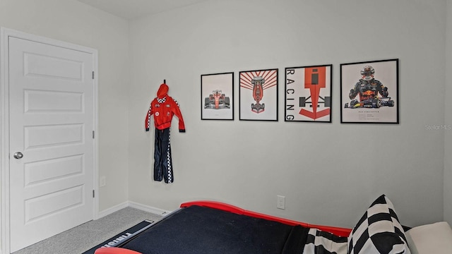bedroom featuring carpet and baseboards