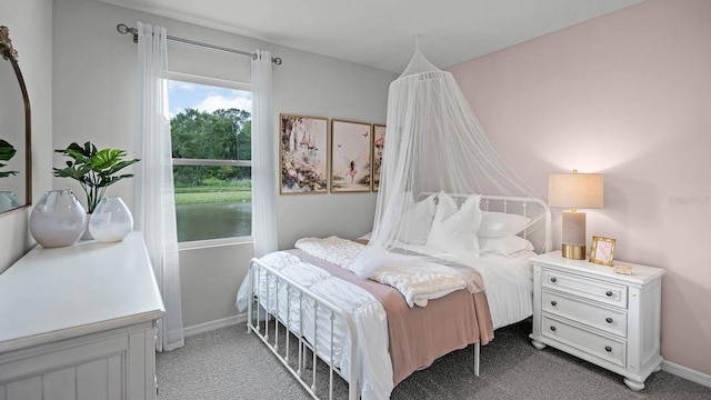 carpeted bedroom with baseboards