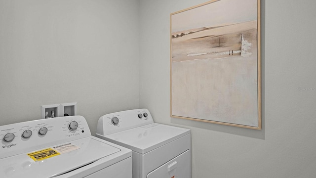 clothes washing area featuring washing machine and clothes dryer and laundry area