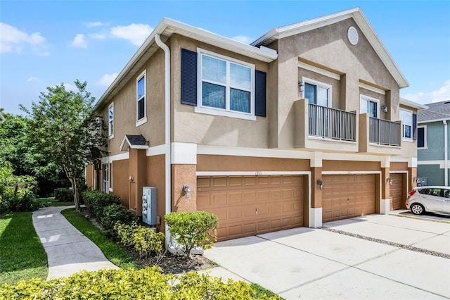 1821 San Jacinto Cir, Sanford, FL 32771 - multi unit property featuring an attached garage, a balcony, stucco siding, and driveway