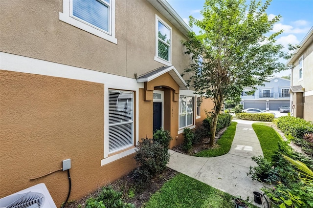 1821 San Jacinto Cir, Sanford, FL 32771 - view of side of home featuring central AC unit and stucco siding