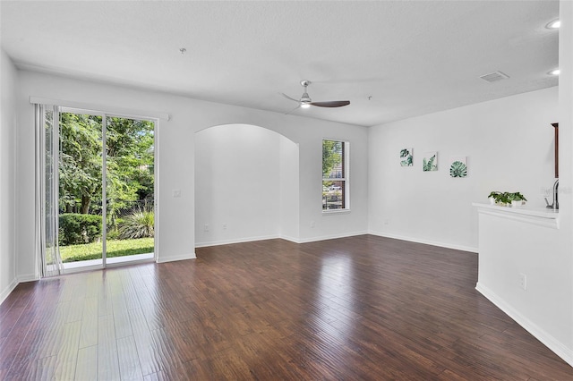 1821 San Jacinto Cir, Sanford, FL 32771 - spare room with visible vents, a ceiling fan, arched walkways, and dark wood-type flooring