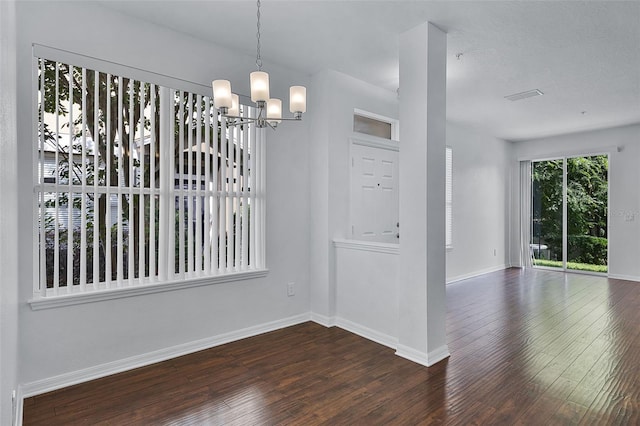 1821 San Jacinto Cir, Sanford, FL 32771 - unfurnished dining area with dark wood-style flooring, baseboards, an inviting chandelier, and visible vents