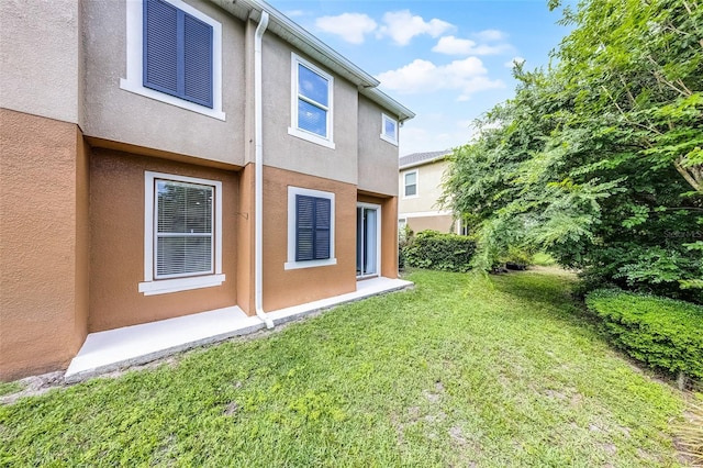 1821 San Jacinto Cir, Sanford, FL 32771 - back of house featuring a yard and stucco siding