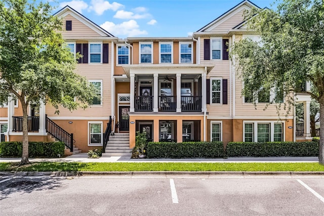 townhome / multi-family property featuring stucco siding and uncovered parking