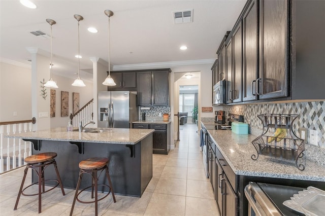 kitchen featuring visible vents, crown molding, decorative backsplash, and appliances with stainless steel finishes