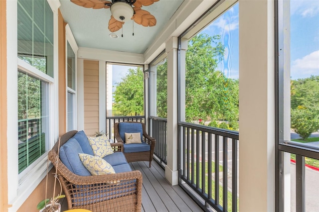 sunroom / solarium featuring a ceiling fan and a healthy amount of sunlight