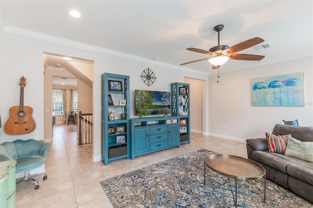 living room featuring crown molding, ceiling fan, visible vents, and light tile patterned floors
