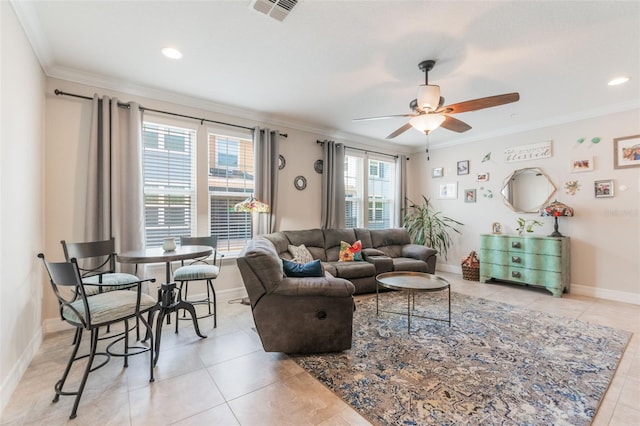living area featuring visible vents, crown molding, light tile patterned flooring, baseboards, and ceiling fan