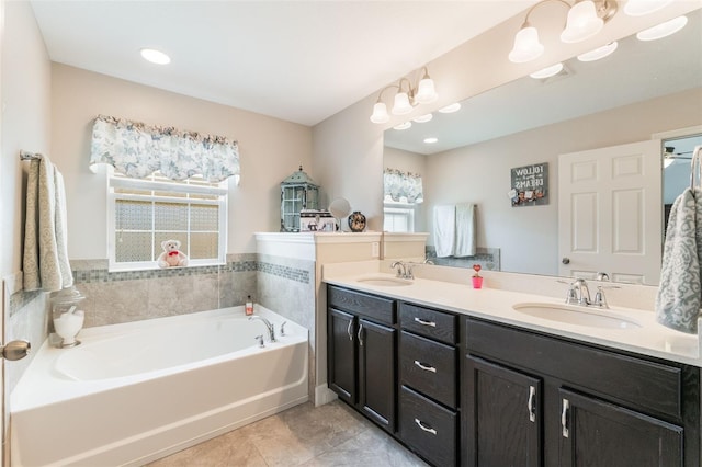 full bathroom featuring a garden tub, a sink, tile patterned floors, and double vanity