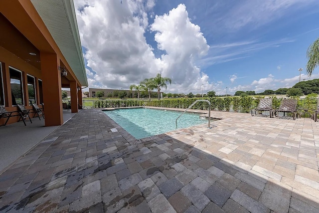 view of pool with a fenced in pool and a patio