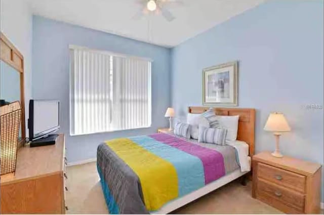 bedroom with baseboards, a ceiling fan, and light colored carpet