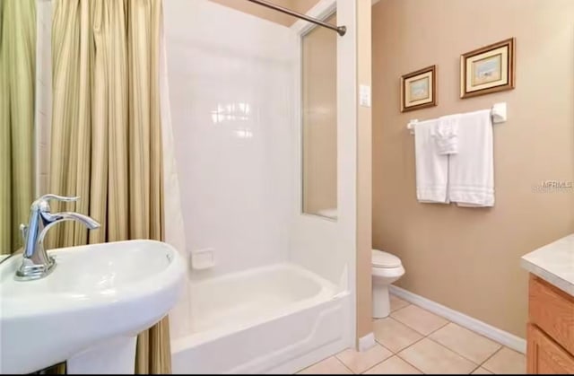 full bath featuring a sink, shower / bathtub combination, toilet, baseboards, and tile patterned flooring