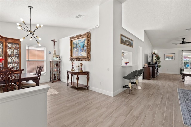 342 Hanging Moss Cir, Lake Mary, FL 32746 - interior space with light wood-style floors, a textured ceiling, vaulted ceiling, and baseboards