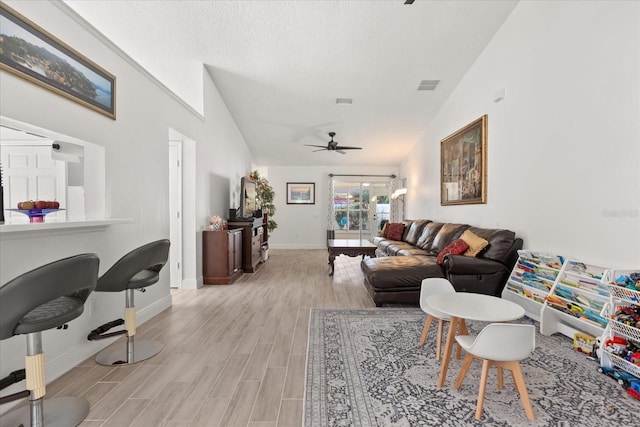 342 Hanging Moss Cir, Lake Mary, FL 32746 - living room with light wood-style floors, baseboards, visible vents, a ceiling fan, and a textured ceiling