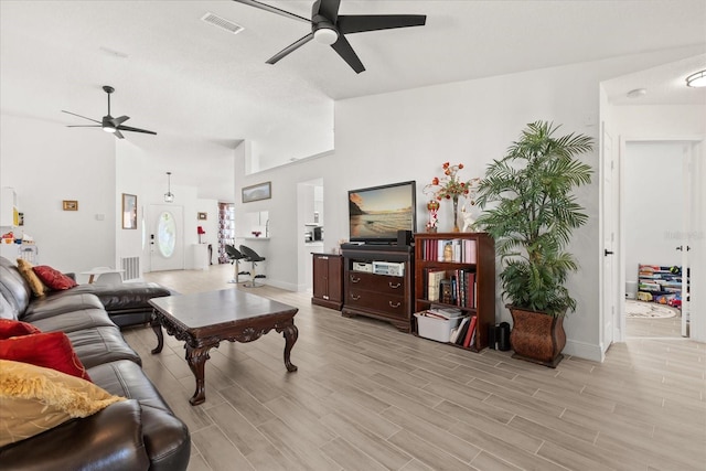 342 Hanging Moss Cir, Lake Mary, FL 32746 - living room featuring lofted ceiling, a ceiling fan, light wood finished floors, and baseboards