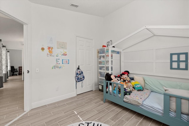 342 Hanging Moss Cir, Lake Mary, FL 32746 - bedroom featuring baseboards, visible vents, and wood tiled floor