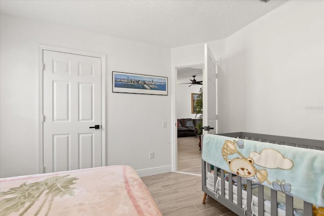 342 Hanging Moss Cir, Lake Mary, FL 32746 - bedroom featuring baseboards, wood finished floors, and a textured ceiling