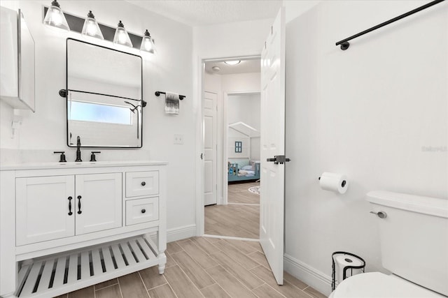 342 Hanging Moss Cir, Lake Mary, FL 32746 - bathroom featuring wood tiled floor, vanity, toilet, and baseboards