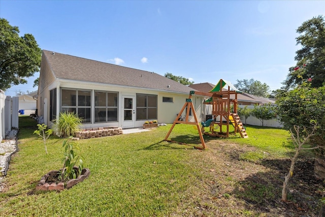 342 Hanging Moss Cir, Lake Mary, FL 32746 - rear view of property with a sunroom, a yard, a playground, roof with shingles, and fence