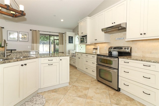 kitchen with light stone countertops, appliances with stainless steel finishes, a sink, decorative backsplash, and under cabinet range hood