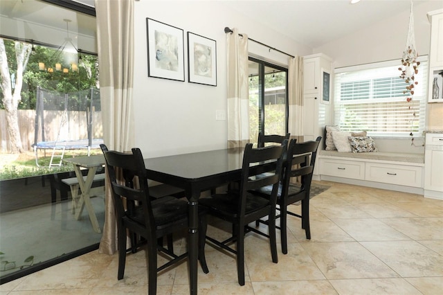 dining space featuring vaulted ceiling