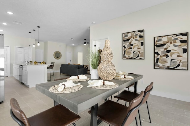 dining room with light tile patterned flooring, ceiling fan, recessed lighting, and baseboards