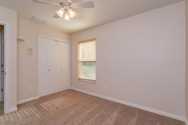 unfurnished bedroom featuring a closet, visible vents, carpet floors, and baseboards