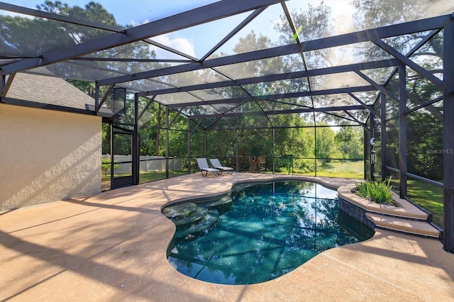 view of swimming pool with a patio, a lanai, and a fenced in pool