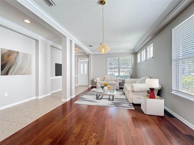 12724 Bideford Ave, Windermere, FL 34786 - living room with a textured ceiling, wood finished floors, and ornamental molding