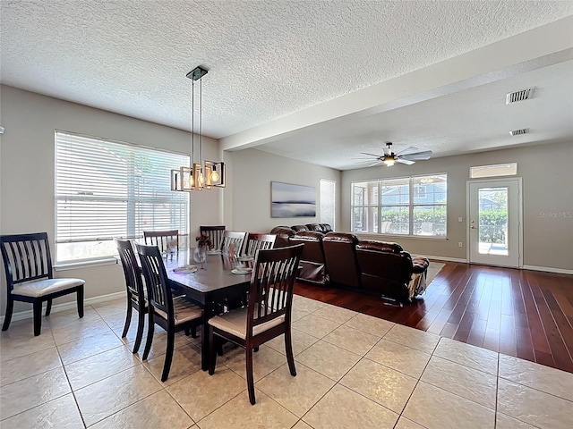 12724 Bideford Ave, Windermere, FL 34786 - dining space featuring light tile patterned flooring, ceiling fan, a chandelier, and a textured ceiling