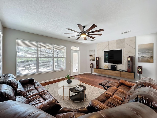 12724 Bideford Ave, Windermere, FL 34786 - living area with wood finished floors, a ceiling fan, and a textured ceiling