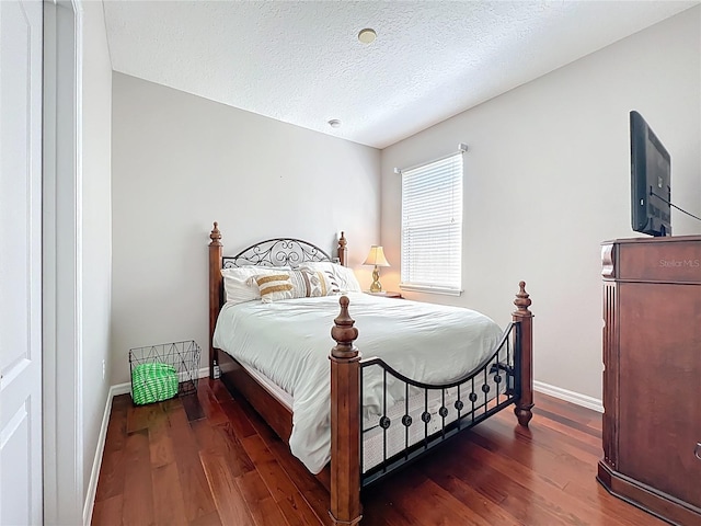 12724 Bideford Ave, Windermere, FL 34786 - bedroom featuring wood finished floors and a textured ceiling