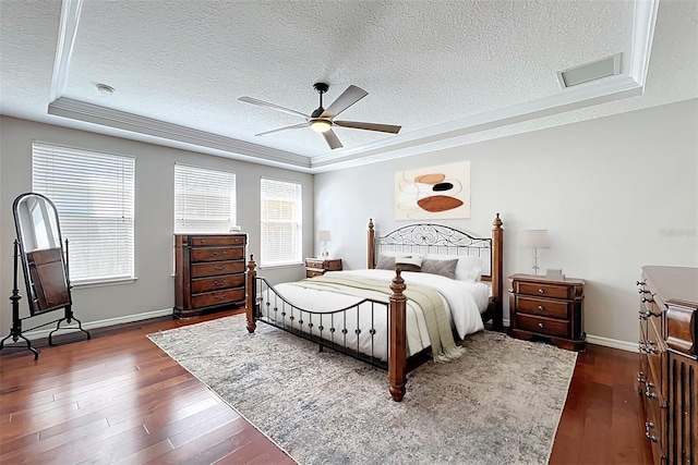 12724 Bideford Ave, Windermere, FL 34786 - bedroom with a textured ceiling, dark wood-type flooring, a raised ceiling, and a ceiling fan