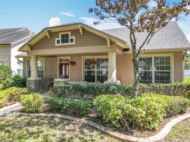 12724 Bideford Ave, Windermere, FL 34786 - view of front of home featuring a porch, stucco siding, and a shingled roof