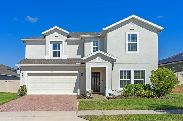 683 Campo Ln, Davenport, FL 33837 - traditional home with an attached garage, decorative driveway, and stucco siding
