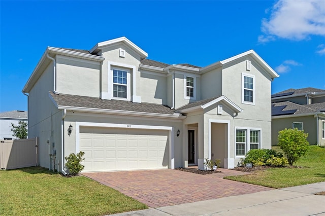 683 Campo Ln, Davenport, FL 33837 - traditional home with a garage, fence, a front yard, decorative driveway, and stucco siding