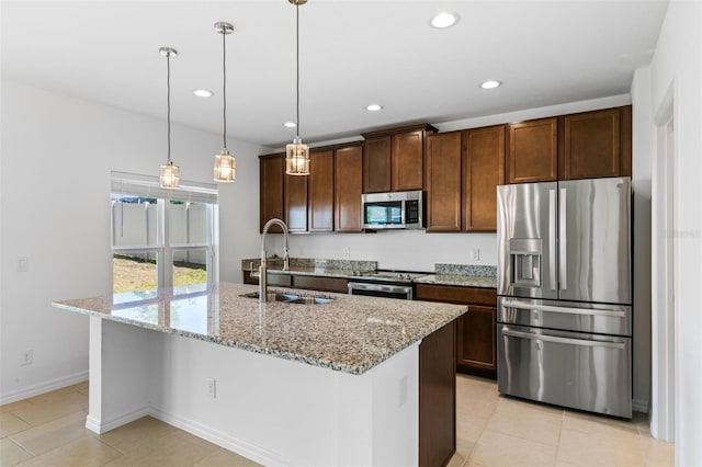683 Campo Ln, Davenport, FL 33837 - kitchen with appliances with stainless steel finishes, a sink, light stone counters, recessed lighting, and an island with sink
