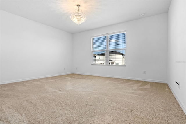 683 Campo Ln, Davenport, FL 33837 - empty room with an inviting chandelier, baseboards, and light carpet