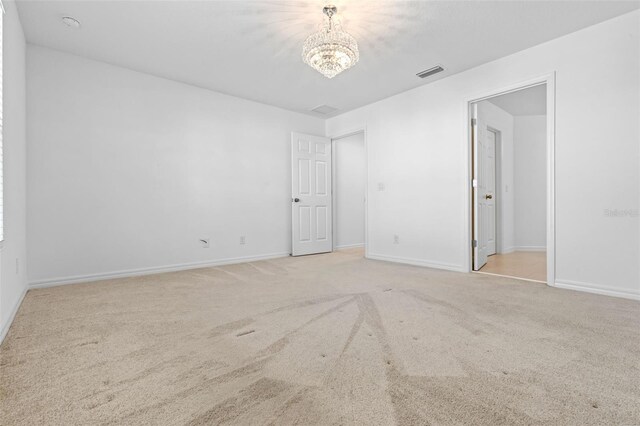 683 Campo Ln, Davenport, FL 33837 - unfurnished bedroom with visible vents, carpet flooring, baseboards, and an inviting chandelier