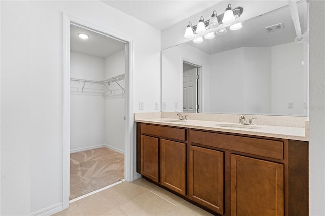683 Campo Ln, Davenport, FL 33837 - full bathroom featuring a sink, a spacious closet, double vanity, and visible vents