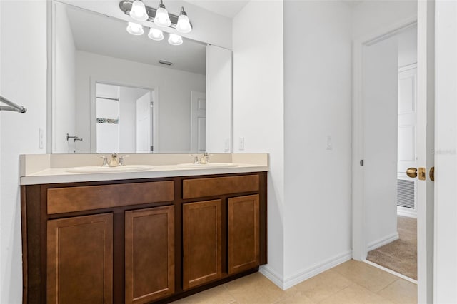 683 Campo Ln, Davenport, FL 33837 - bathroom featuring double vanity, baseboards, visible vents, and a sink