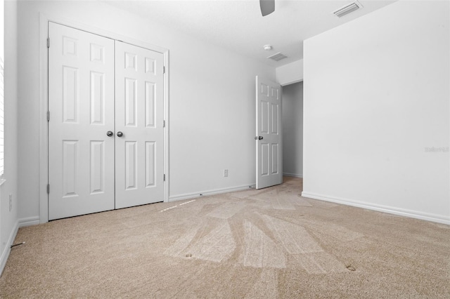 683 Campo Ln, Davenport, FL 33837 - unfurnished bedroom with baseboards, visible vents, and light carpet