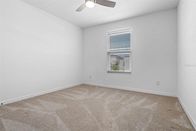 683 Campo Ln, Davenport, FL 33837 - spare room with light colored carpet, baseboards, and ceiling fan