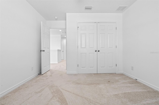 683 Campo Ln, Davenport, FL 33837 - unfurnished bedroom with visible vents, baseboards, a closet, and light carpet