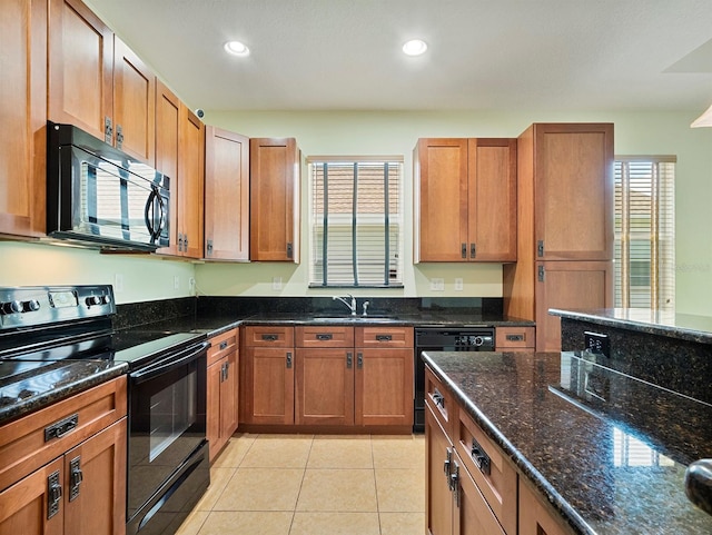 kitchen featuring brown cabinets, light tile patterned flooring, a sink, recessed lighting, and black appliances