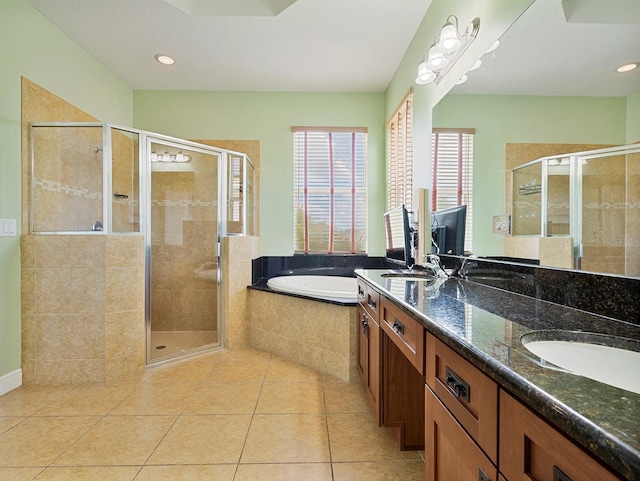 bathroom with tile patterned flooring, a bath, a sink, and a stall shower