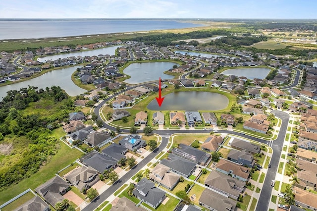 drone / aerial view featuring a water view and a residential view