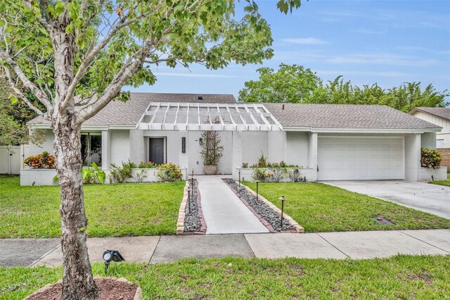 1218 Fairway Dr, Winter Park, FL 32792 - mid-century home featuring a shingled roof, an attached garage, driveway, and a front lawn