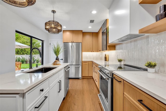 1218 Fairway Dr, Winter Park, FL 32792 - kitchen featuring appliances with stainless steel finishes, a sink, premium range hood, open shelves, and light wood-type flooring